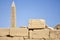 Tall pillar with carved ancient hieroglyphs in Karnak Temple complex. Legacy of past centuries, heritage. Luxor, Egypt.