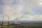 Tall pipes of power plant, white smoke on rural landscape and blue sky copy space background