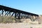 Tall railway bridge desert gorge blue sky