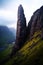 a tall rock formation in a valley