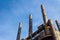 Tall, rusting smoke stacks silhouetted against a bright blue sky, abandoned industrial complex, copy space