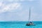 Tall sailboat on open clear blue ocean water landscape