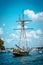 Tall ship setting sail from South Haven Michigan`s harbor on a sunny summer day