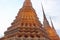 The tall spires of the ancient Buddhist monastery of Wat Pho in the city of Bangkok
