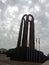 Tall statue tower with a cloudy sky in the background