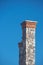 Tall stone chimney against clear deep blue sky 1