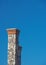 Tall stone chimney against clear deep blue sky 3