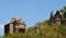 Tall stone gothic houses set in the woodland landscape i hebden bridge west yorkshire with blue sky