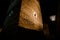 Tall stone tower illuminated at night by an ancient lamppost, in the castle of Bari