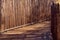 Tall, straight, stick wood fence and plank path, walkway, eco fr