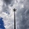 Tall street light pole against sky