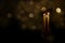 Tall Taper Candles With Golden Bokeh Lights