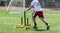 Tall teenager pushing yellow sled with weight for strength and speed practice