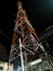 The tall telecommunication pole in the dark