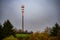 Tall telecommunications and 5G cell tower with microwave antennas in fall