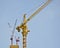 Tall tower cranes on construction site.