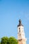 A tall tower with a spire and a dome. Temple