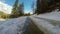 Tall water from the snow fills the road. Spring forest immediately after the snow melts