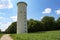 Tall water tower on a meadow in Germany