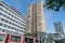 Tall wavy shaped  brown tiled facade of building by Thon Hotels building from street level