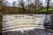 Tall weir on the River Etherow. Etherow Country Park, Stockport, Cheshire, UK