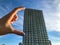 A tall white house made of aerated concrete. with panoramic glazing, in Arabic style with terraces. girl holding fingers,