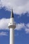 Tall white minaret of a Muslim mosque an Islamic shrine, reading the Koran through a loudspeaker on the minaret