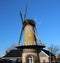 Tall windmill in krimpen aan den ijssel along river Hollandse IJssel