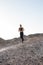 Tall woman jogging along a path in the desert