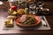 Tallarines verdes con chuleta de cerdo green pasta and pork chop Peruvian comfort food buffet traditional table