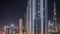 Tallest skyscrapers in downtown dubai located on bouleward street near shopping mall aerial all night timelapse.