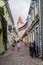 TALLINN, ESTONIA - AUGUST 22, 2016: People walk on a narrow cobbled street in the old town in Tallin