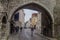 TALLINN, ESTONIA - AUGUST 22, 2016: Pikk street leading through a gate next to Fat Margaret tower in the old town of