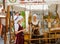 TALLINN, ESTONIA - JULY 8, 2006: Tourists in Old City. Sellers of almond nuts in medieval dresses.