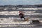 Tallinn, Estonia - October 18, 2008: Kitesurfer in a suit rides on the waves in the spray of the waves.