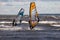 Tallinn, Estonia - October 18, 2008: Two windsurfers in suits ride on boards with a sail on the waves on the sea