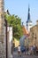 Tallinn, Estonia, Old town. Peak Street. Church Oleviste spire is seen in the distance.