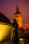 TALLINN, ESTONIA: Statue of a monk without a face. St. Nicholas ` Church, Niguliste kirik. Night landscape with lighting