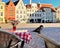 Tallinn, old town hall square, spring street, cafe, glass with flowers on the tabletop, sparrow birds sitting on a chair, empty ci