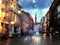 Tallinn Rainy old town people walk with umbrellas medieval city  night blurred light on pavement lifestyle