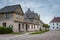 Talsi, Latvia - July 12, 2018: Colorful old town houses with lake reflection in cloudy summer day