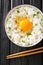 Tamago Kake Gohan Japanese Style Rice With Egg close up in the bowl. Vertical top view