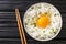 Tamago kake gohan is a simple Japanese dish made of raw Egg Over Rice close up in the bowl. Horizontal top view