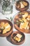 Tamago served on wooden plate on white table background with flowers. Japanese oven baked omelette Tamagoyaki or egg roll
