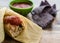 Tamale served with blue corn tortillas and tomato sauce side vie