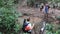 TAMAN NEGARA, MALAYSIA - MARCH 16, 2018: Tourists are crossing a creek in the jungle of Taman Negara national park