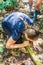 TAMAN NEGARA, MALAYSIA - MARCH 17, 2018: Tourists is drinking water from a bamboo in the jungle of Taman Negara national