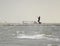 Tampa, FL, February 2022 - Kite surfer is riding the waves and takes off into the air during a storm