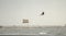 Tampa, FL, February 2022 - Kite surfer is riding the waves and takes off into the air during a storm