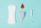 Tampon, Pad, menstrual cup with a drop of blood on a blue background. The view is flat. Concept of critical days, menstruat